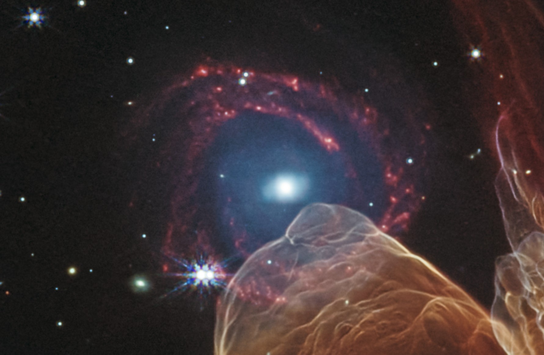 Fragment Herbig-Haro 49/50 z widoczną w tle galaktyką